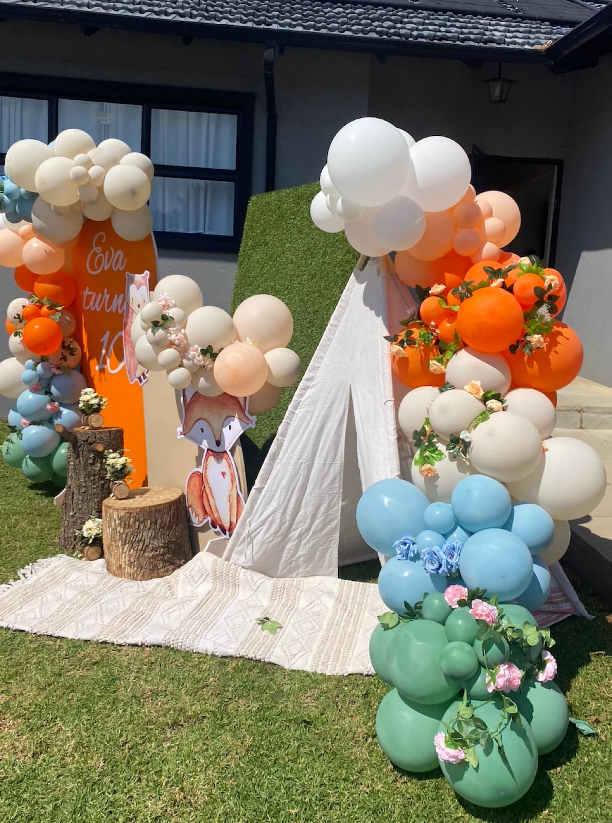 Woodland fox themed 10th birthday with orange, cream and sage balloon garlands and a teepee