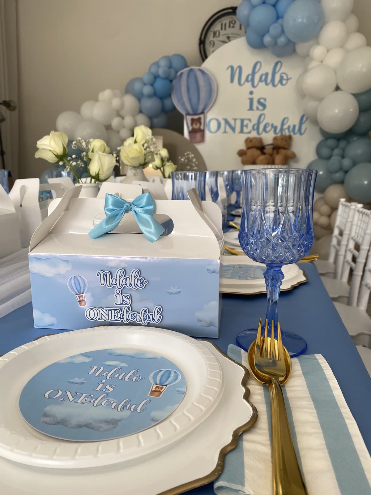 Blue and white table setting with a crown for a first birthday party