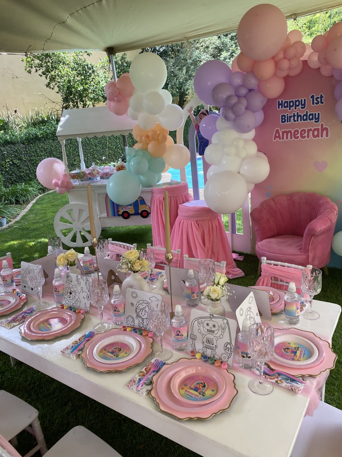 Pink pastel balloon arch and styled table for a first birthday party