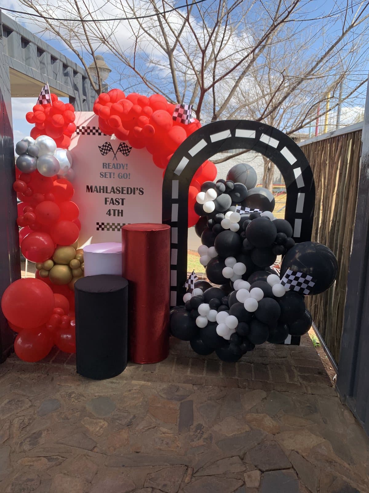 Red, black and white racing themed balloon arch