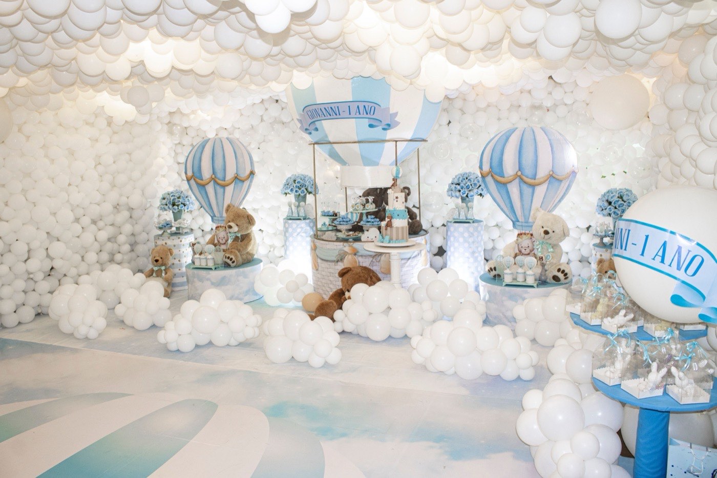 An elaborate hot air balloon themed first birthday display with teddy bears